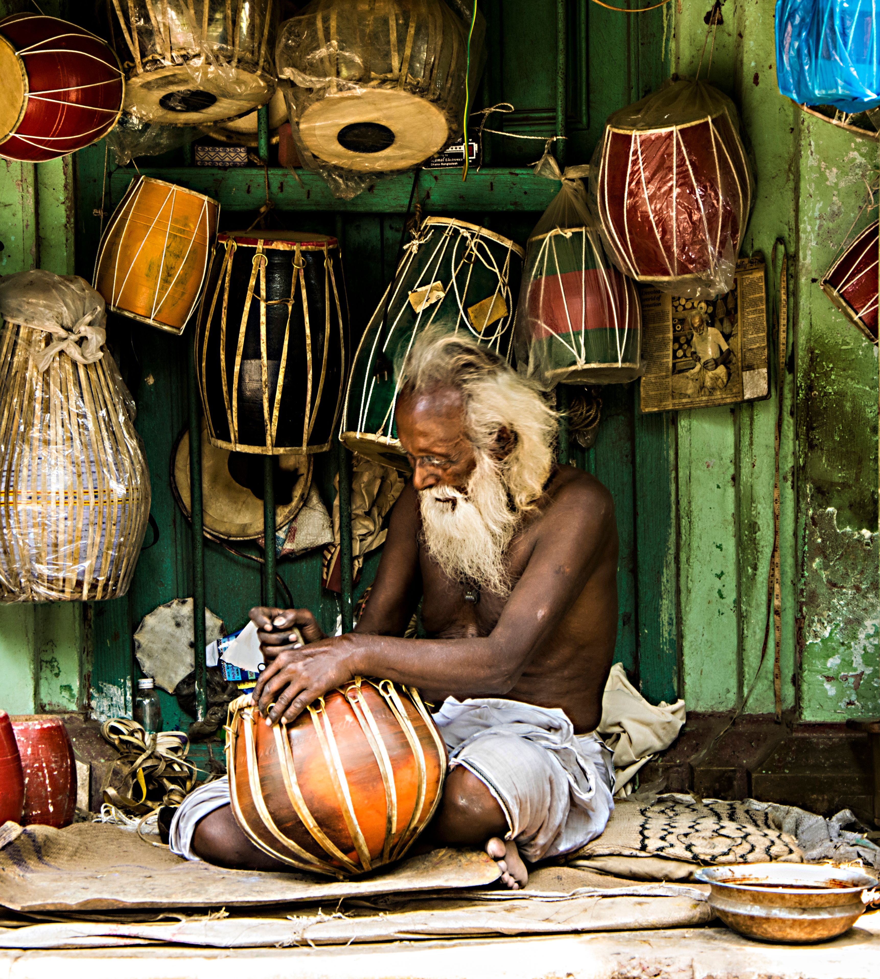 A full-length tanpura drone instrument with a wide pumpkin gourd resonator and long straight neck in deep rosewood, with four thick bronze strings